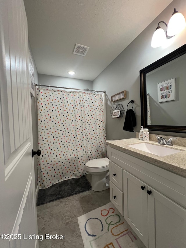 bathroom with vanity, a shower with curtain, and toilet