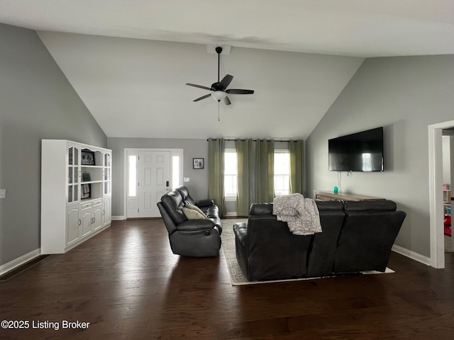 living room with ceiling fan, dark hardwood / wood-style floors, and vaulted ceiling