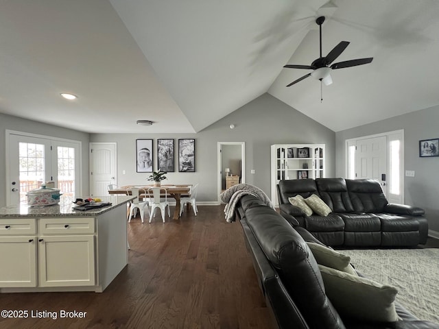 living room with dark hardwood / wood-style flooring, vaulted ceiling, and ceiling fan