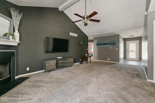 carpeted living room featuring lofted ceiling with beams, ceiling fan, and a textured ceiling