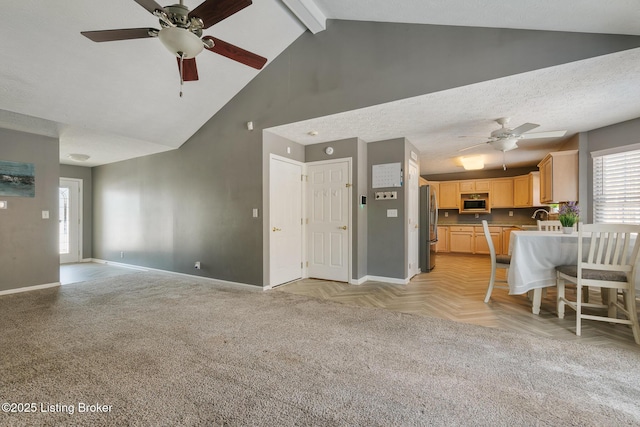 unfurnished living room featuring a textured ceiling, ceiling fan, sink, lofted ceiling with beams, and light parquet flooring