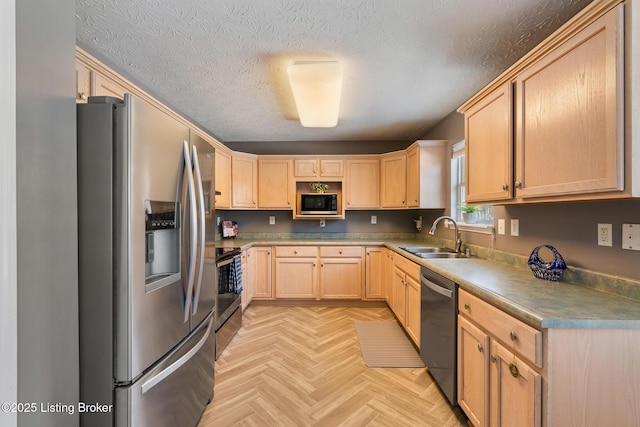 kitchen with sink, a textured ceiling, light brown cabinetry, stainless steel appliances, and light parquet flooring