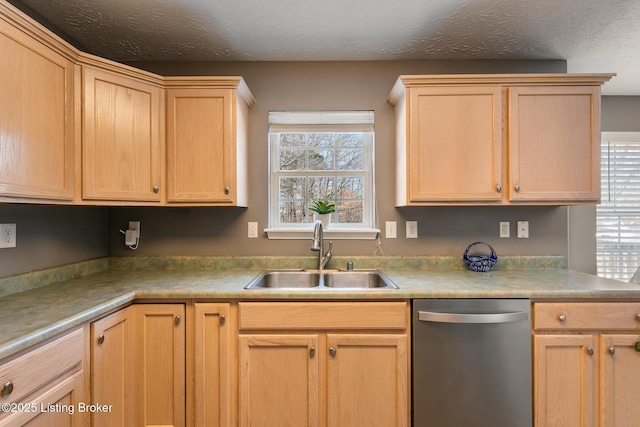 kitchen with dishwasher, light brown cabinets, and sink