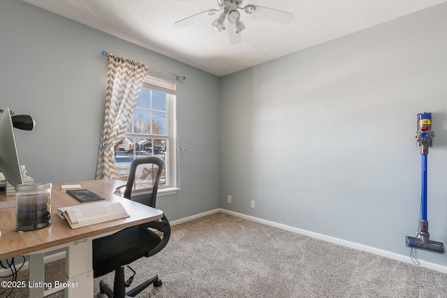 carpeted office space featuring ceiling fan and a textured ceiling