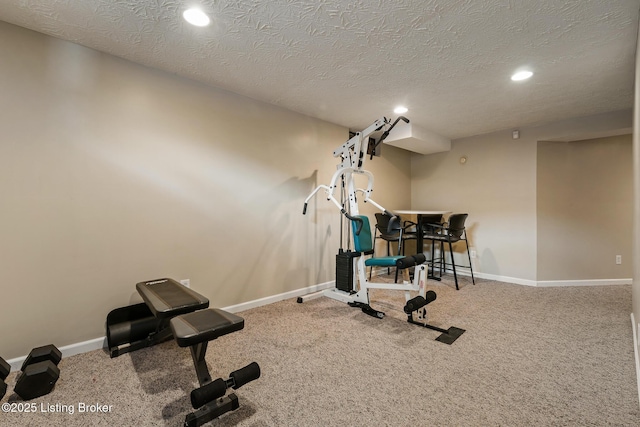 exercise room featuring carpet and a textured ceiling