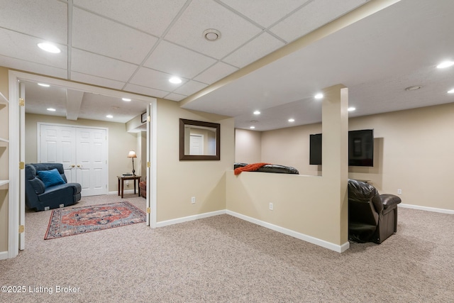 interior space featuring a paneled ceiling and carpet floors