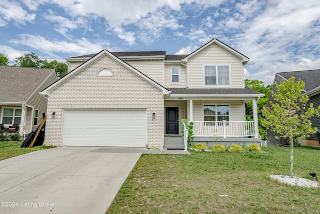 view of front of property with covered porch, a garage, and a front lawn