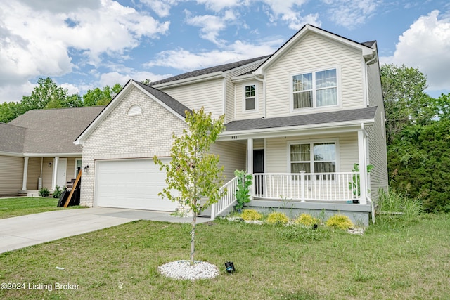 view of front of property with a garage, covered porch, and a front lawn