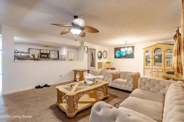 living room featuring ceiling fan with notable chandelier and carpet floors