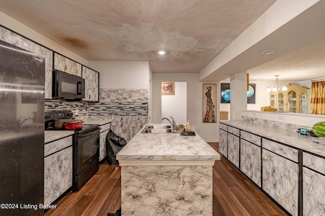 kitchen with sink, black range with electric stovetop, an island with sink, and dark wood-type flooring