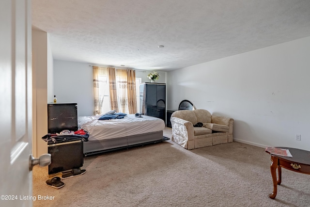 carpeted bedroom featuring a textured ceiling