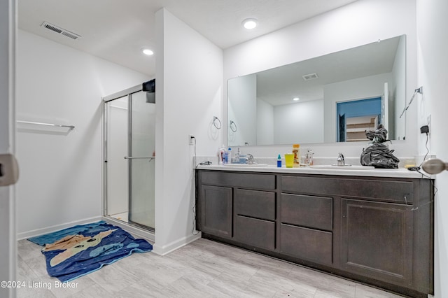 bathroom with vanity and an enclosed shower