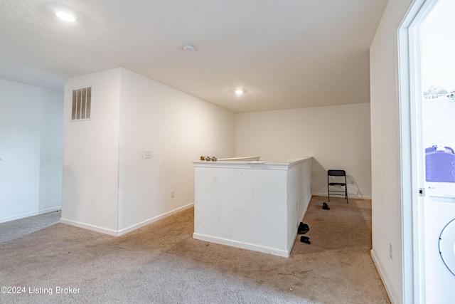 interior space featuring light carpet and washer / clothes dryer