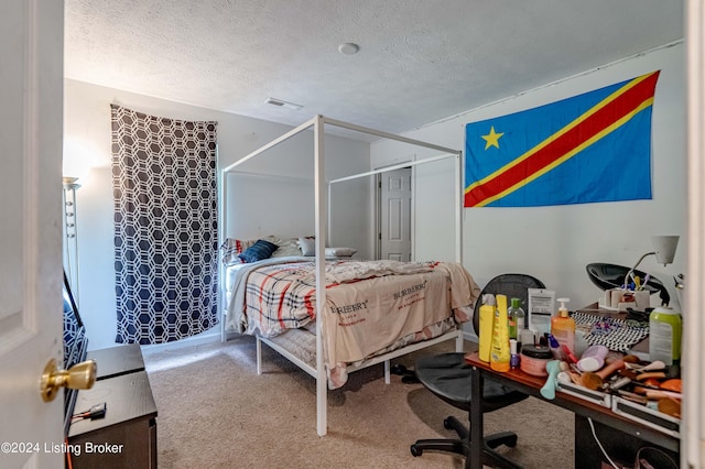 carpeted bedroom with a textured ceiling