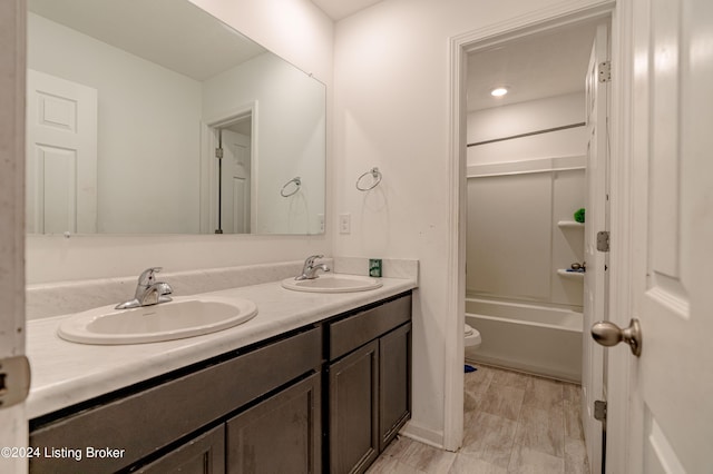 full bathroom with bathing tub / shower combination, vanity, and toilet