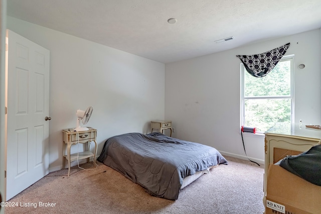 bedroom featuring light carpet