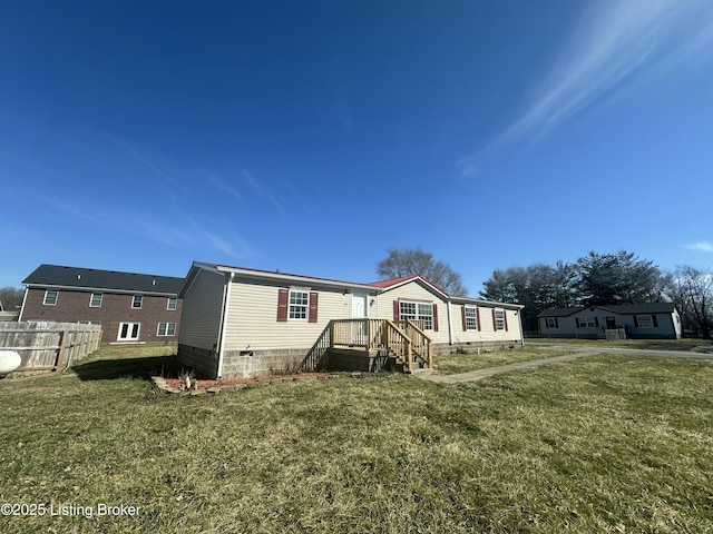 manufactured / mobile home with a front lawn, fence, and crawl space