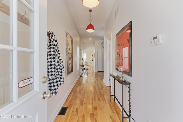 hallway with light wood-type flooring