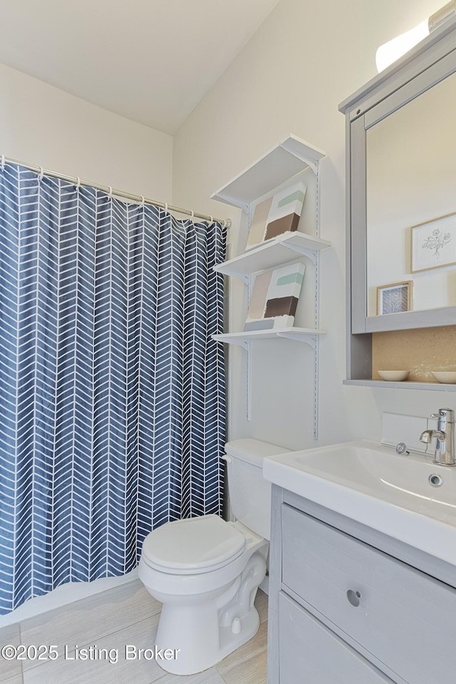 bathroom with toilet, vanity, and a shower with curtain