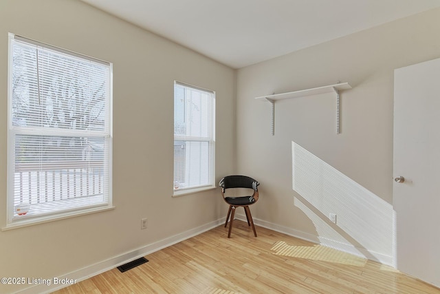 empty room with light hardwood / wood-style flooring