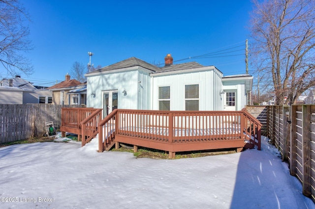 rear view of house with a deck and french doors