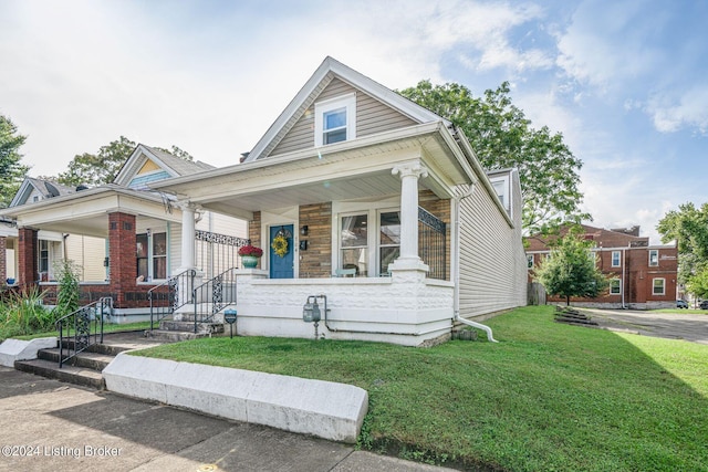 view of front of house featuring a front lawn and covered porch