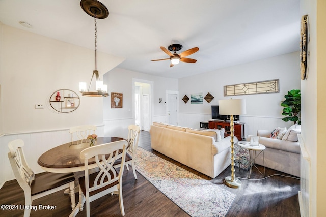 living room featuring wood-type flooring and ceiling fan