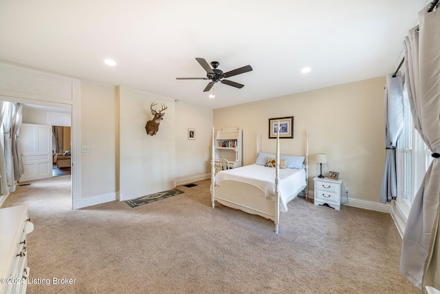 bedroom featuring ceiling fan and light carpet