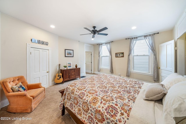 bedroom with ceiling fan and light carpet