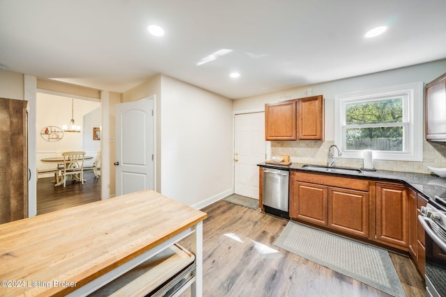 kitchen featuring pendant lighting, decorative backsplash, sink, and stainless steel appliances