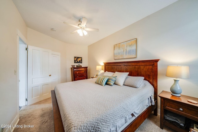 carpeted bedroom featuring ceiling fan and a closet