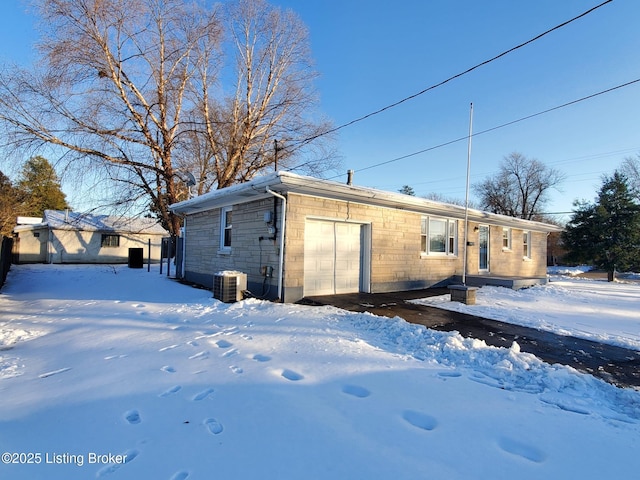 view of snowy exterior with central air condition unit