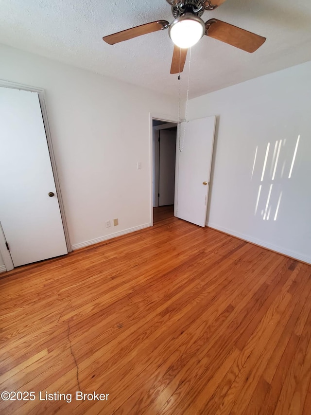 unfurnished bedroom featuring ceiling fan, light hardwood / wood-style flooring, and a textured ceiling