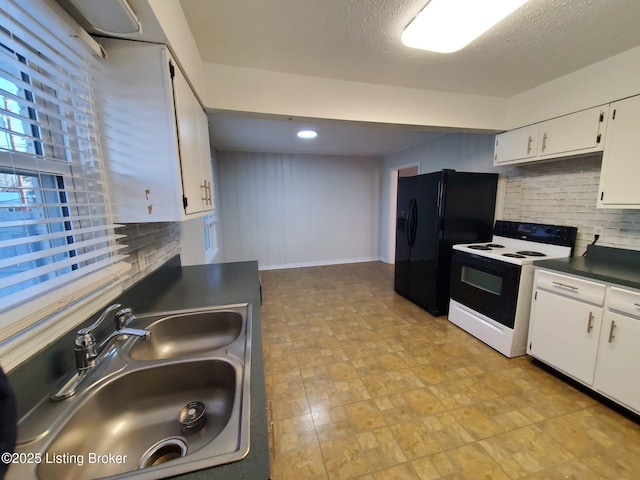 kitchen with black fridge, tasteful backsplash, electric range, white cabinetry, and sink