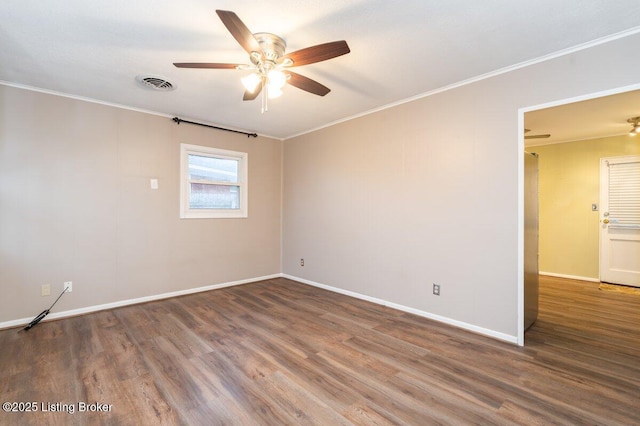 empty room with ceiling fan, hardwood / wood-style floors, and crown molding