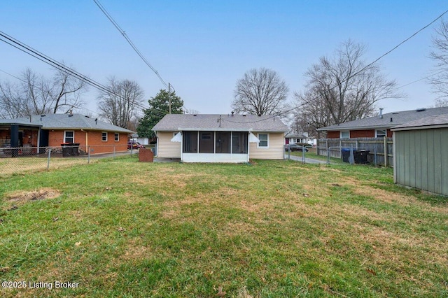 back of house with a sunroom and a lawn