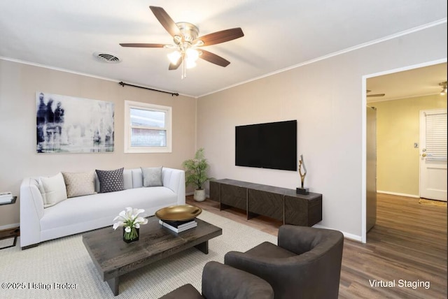 living room with ceiling fan, ornamental molding, and wood-type flooring