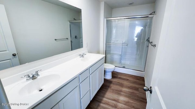 bathroom with vanity, toilet, wood-type flooring, and walk in shower