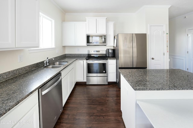 kitchen featuring crown molding, dark hardwood / wood-style flooring, white cabinetry, appliances with stainless steel finishes, and sink