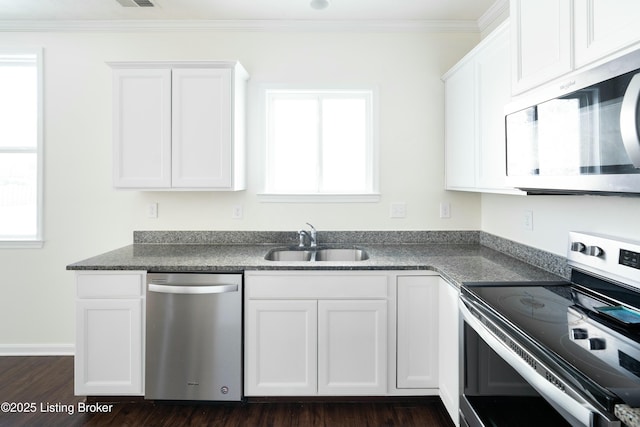 kitchen with sink, stainless steel appliances, white cabinetry, and crown molding