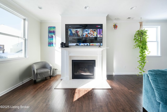 living room with dark hardwood / wood-style flooring and crown molding