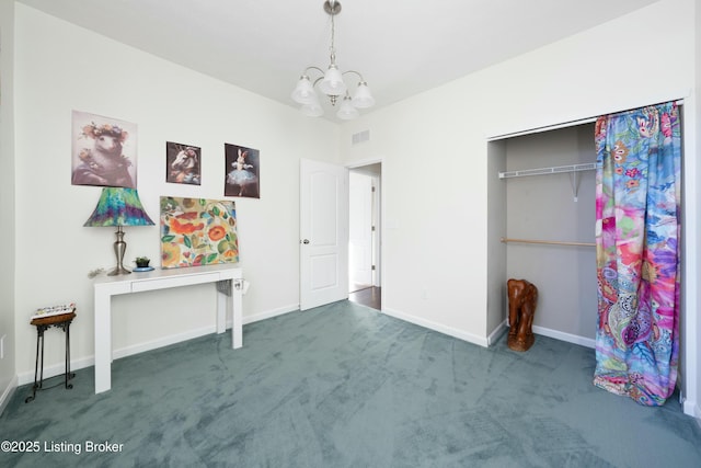 unfurnished bedroom with an inviting chandelier, a closet, and dark carpet