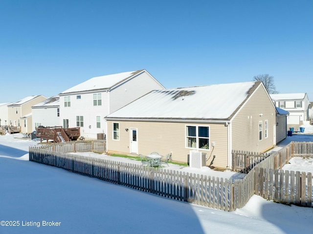 view of snow covered rear of property