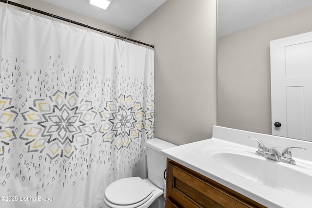 bathroom with toilet and vanity