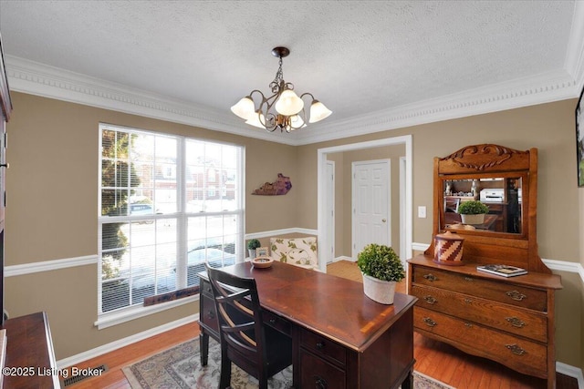 office with plenty of natural light, an inviting chandelier, and light hardwood / wood-style flooring