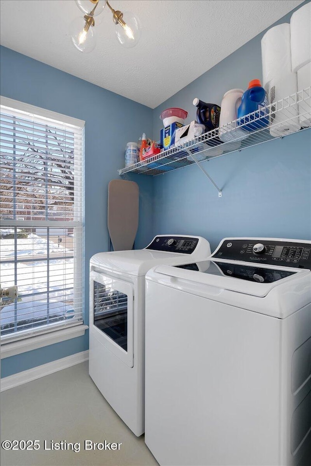 laundry area featuring washing machine and dryer and a textured ceiling