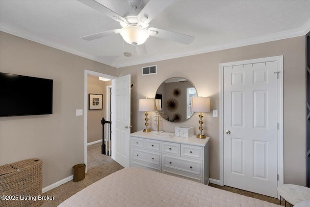 bedroom featuring ornamental molding, light colored carpet, and ceiling fan