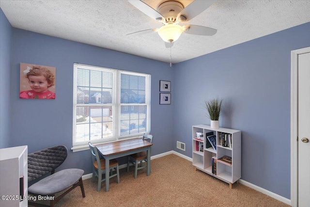 interior space featuring ceiling fan, a textured ceiling, light colored carpet, and a healthy amount of sunlight