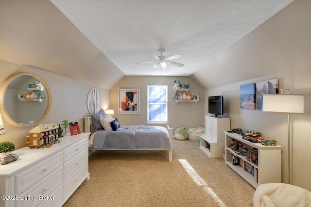 carpeted bedroom featuring ceiling fan, lofted ceiling, and a textured ceiling