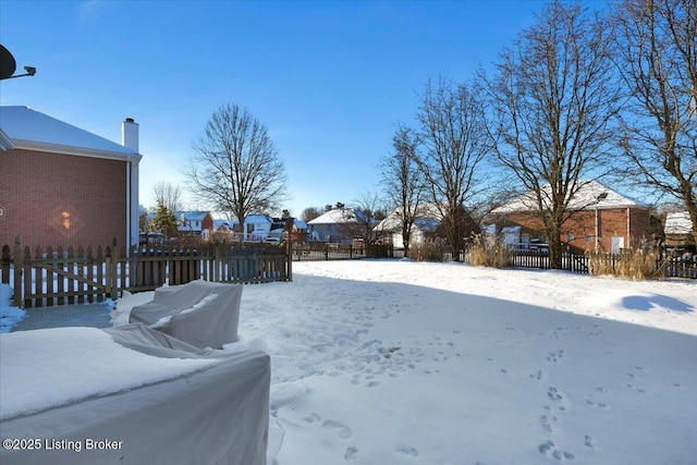 view of yard layered in snow